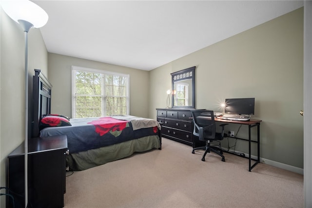 bedroom featuring multiple windows and light colored carpet