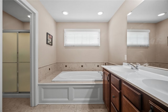 bathroom with vanity, a healthy amount of sunlight, and independent shower and bath