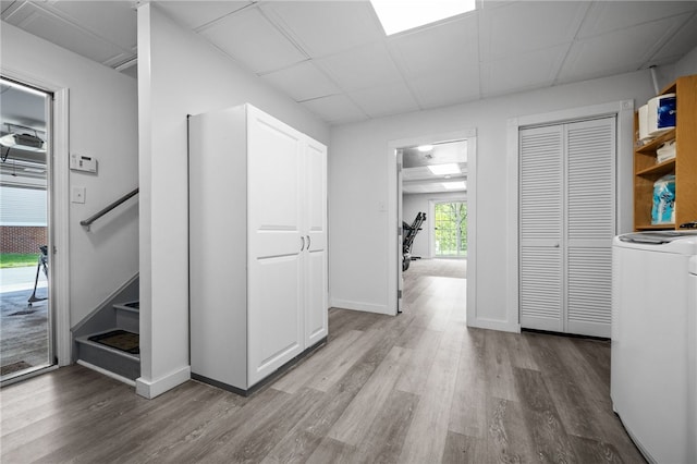 hall with washer / dryer and hardwood / wood-style floors