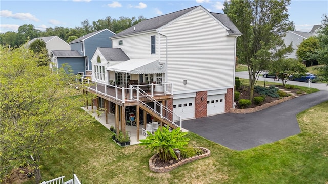 back of house with a yard and a garage