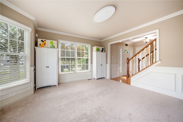 unfurnished room with crown molding and carpet