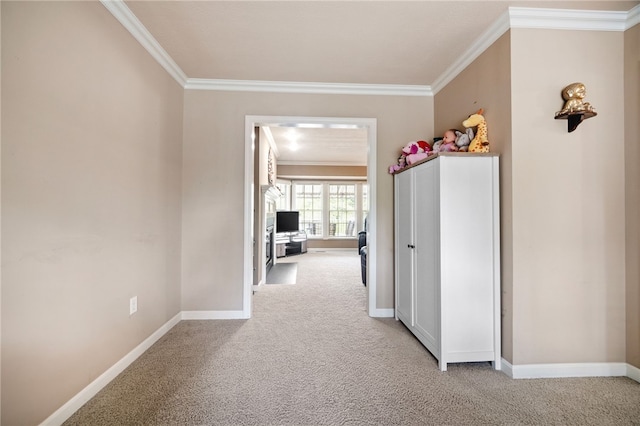 hallway featuring ornamental molding and light colored carpet