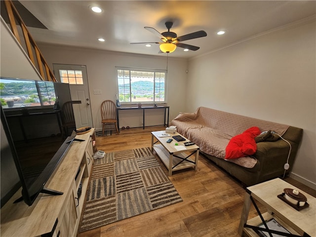 living room featuring ceiling fan, crown molding, and hardwood / wood-style flooring