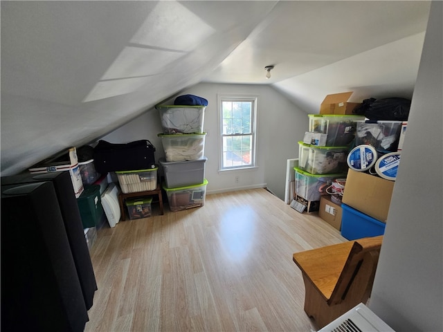 bonus room featuring lofted ceiling and light hardwood / wood-style floors