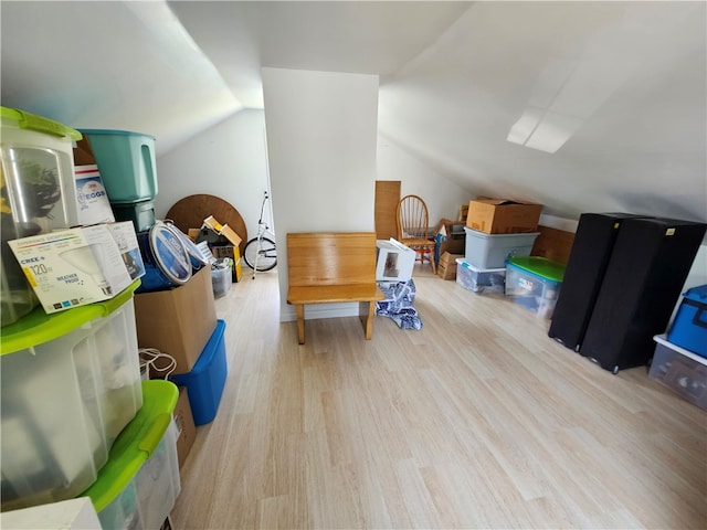 additional living space featuring light hardwood / wood-style flooring and lofted ceiling