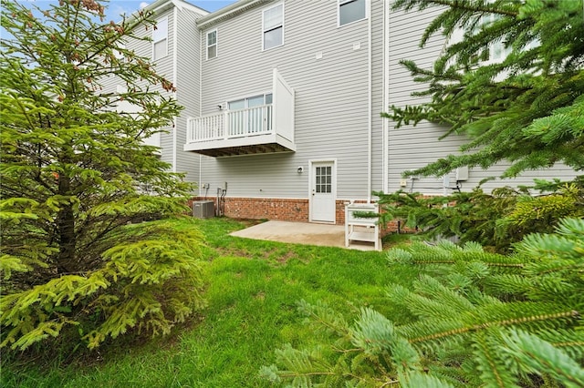 back of property featuring a balcony, a patio, and central air condition unit