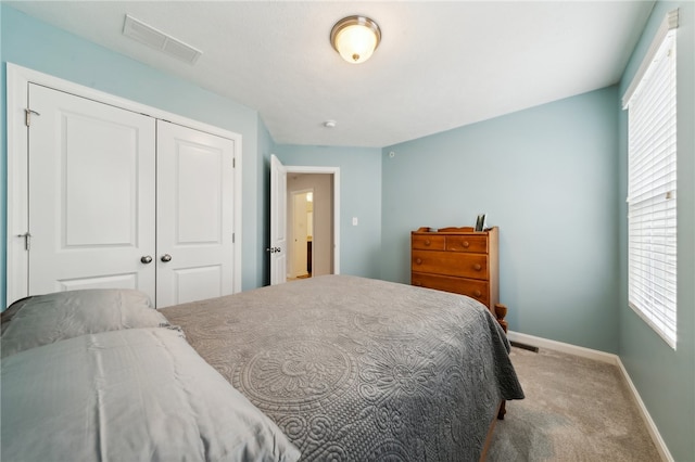 bedroom with a closet and carpet flooring