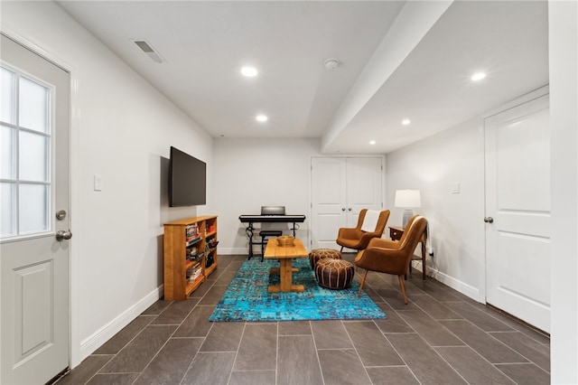 sitting room featuring dark tile patterned flooring