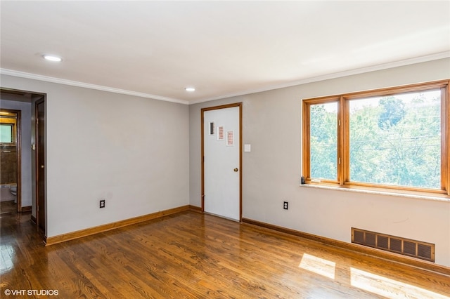 spare room with hardwood / wood-style floors and ornamental molding