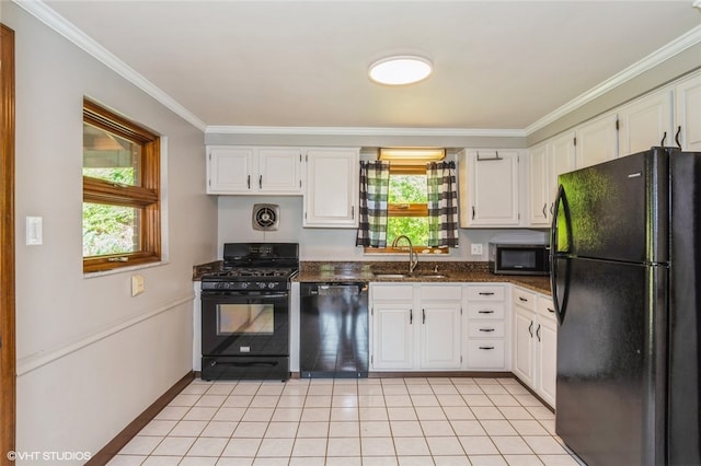 kitchen featuring sink, light tile patterned flooring, a healthy amount of sunlight, and black appliances