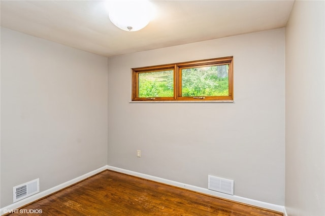 unfurnished room with hardwood / wood-style floors