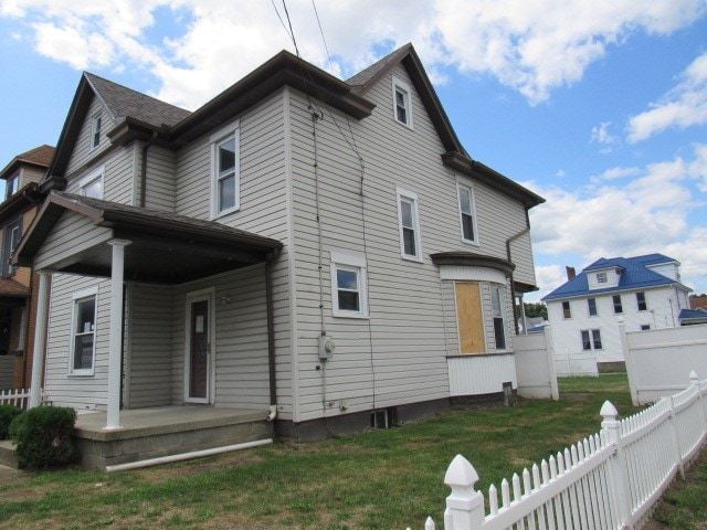 rear view of house with a lawn