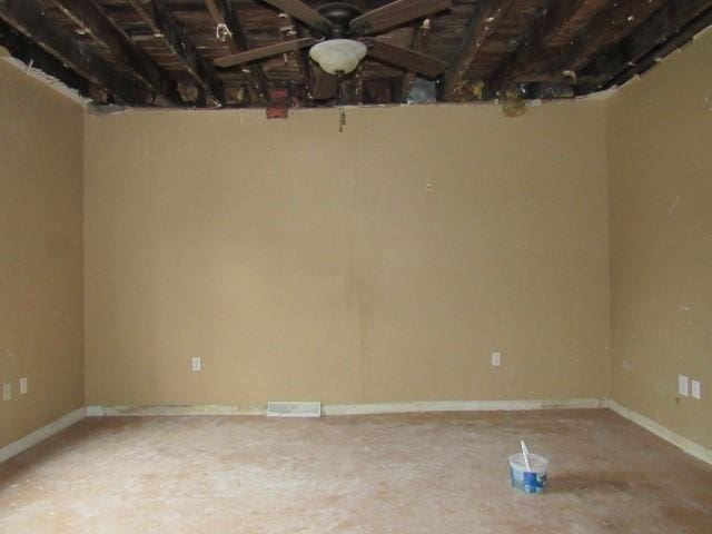 unfurnished room with baseboards