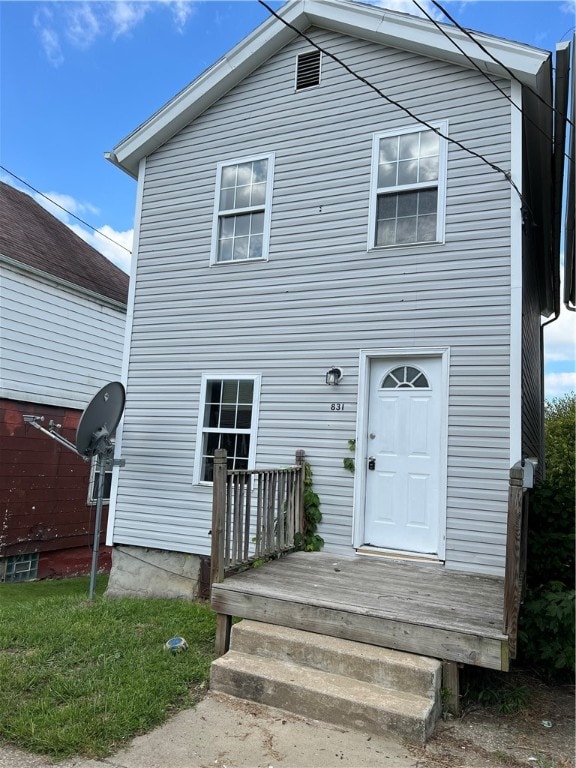 rear view of property featuring a deck