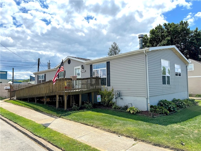 view of front of home featuring a front yard and a deck