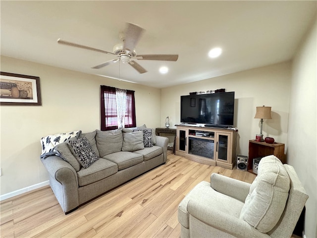 living room featuring light wood-type flooring and ceiling fan