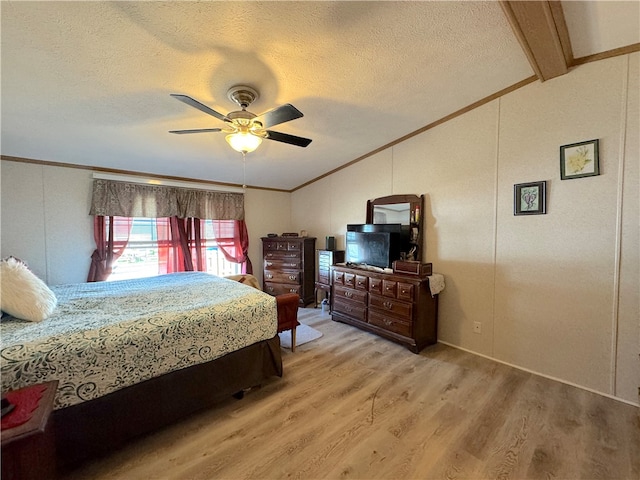 bedroom featuring a textured ceiling, vaulted ceiling with beams, ceiling fan, and hardwood / wood-style flooring