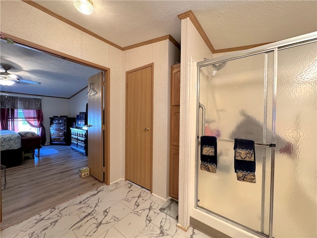 bathroom featuring a textured ceiling, ceiling fan, wood-type flooring, and walk in shower