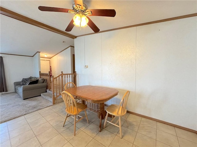 dining space featuring crown molding, light colored carpet, vaulted ceiling, and light tile patterned floors