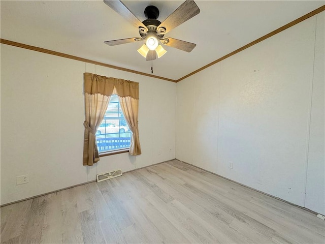 unfurnished room featuring ornamental molding, ceiling fan, light wood finished floors, and visible vents