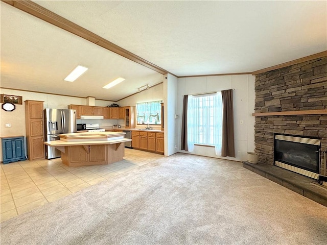 kitchen featuring light colored carpet, lofted ceiling with beams, stainless steel appliances, light countertops, and under cabinet range hood