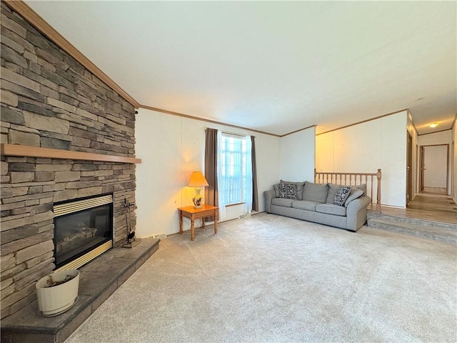 living room with crown molding, light colored carpet, and a fireplace