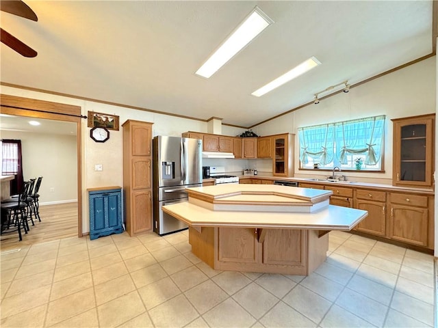 kitchen featuring lofted ceiling, a kitchen island, light countertops, white gas stove, and stainless steel refrigerator with ice dispenser