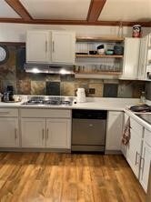 kitchen featuring white cabinets, light wood-type flooring, stainless steel dishwasher, and gas stovetop