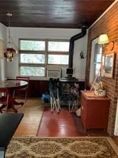 interior space with hardwood / wood-style flooring and a wood stove