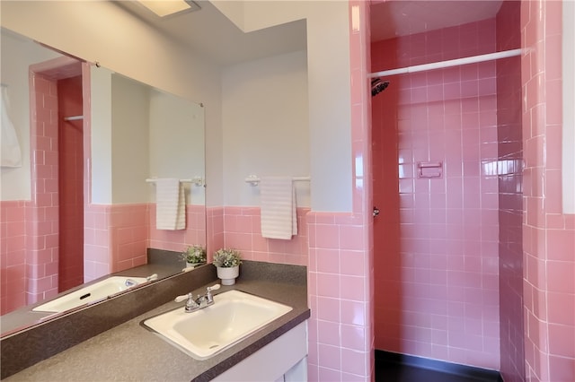 bathroom with tile walls, a tile shower, backsplash, and vanity