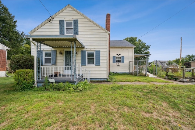 rear view of house featuring a lawn