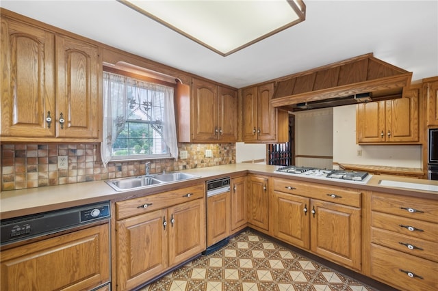 kitchen featuring decorative backsplash, paneled dishwasher, custom range hood, white gas cooktop, and sink