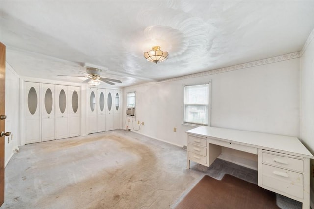 unfurnished office featuring light carpet, ceiling fan, and cooling unit