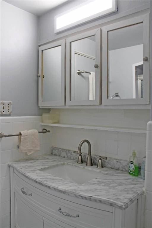 bathroom featuring tile walls and vanity