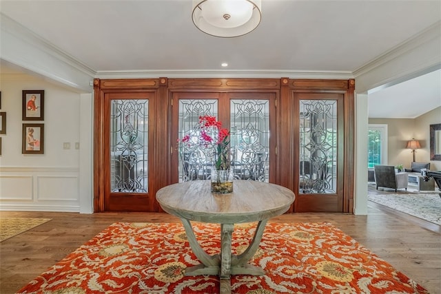 entryway featuring crown molding and hardwood / wood-style floors