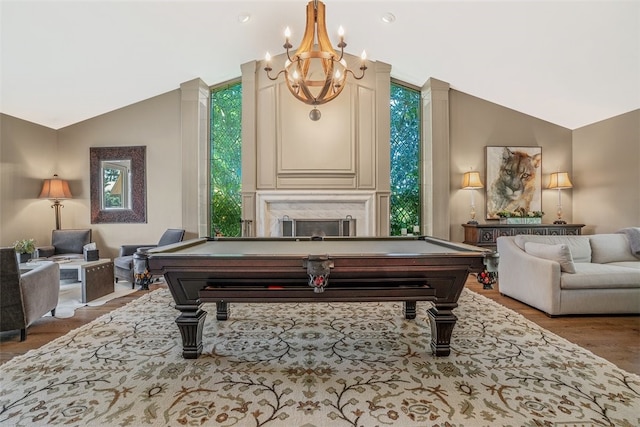 rec room featuring billiards, lofted ceiling, light wood-type flooring, and a premium fireplace