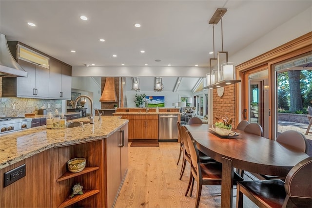 kitchen featuring light hardwood / wood-style flooring, backsplash, dishwasher, light stone countertops, and lofted ceiling with beams