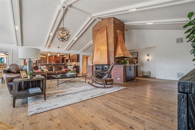 living room featuring high vaulted ceiling, beamed ceiling, and hardwood / wood-style floors