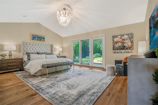 bedroom with light wood-type flooring, access to outside, a notable chandelier, and lofted ceiling