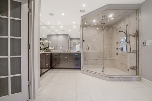 bathroom with tile patterned floors, an enclosed shower, and vanity