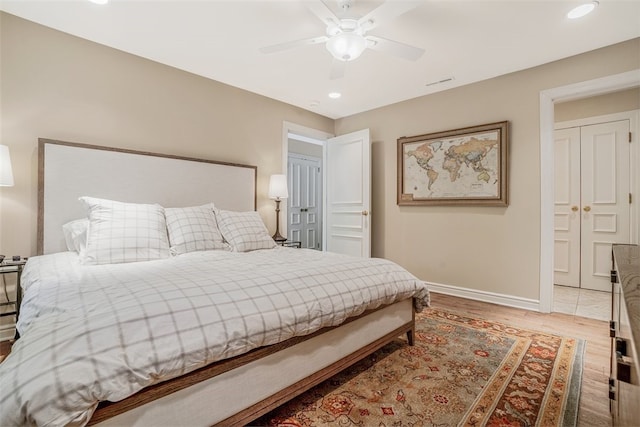 bedroom with ceiling fan and light wood-type flooring