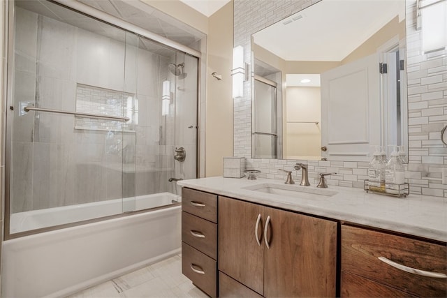 bathroom with combined bath / shower with glass door, tasteful backsplash, vanity, and tile patterned floors