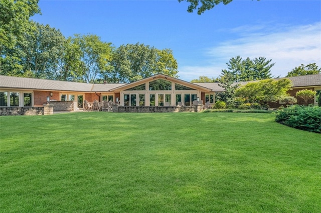 back of house featuring a yard