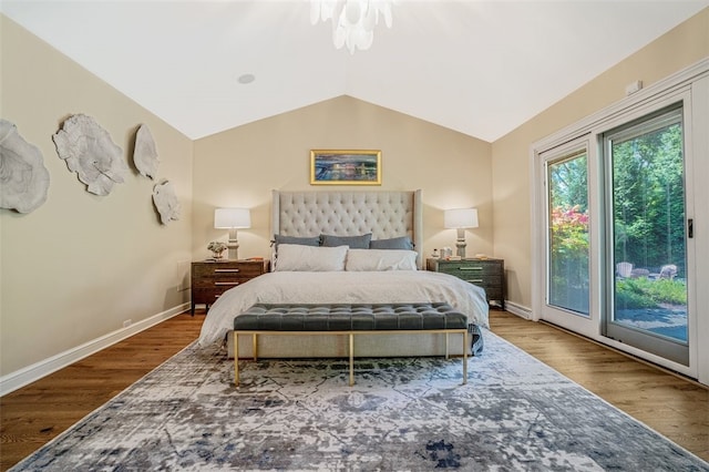 bedroom featuring vaulted ceiling, access to outside, and wood-type flooring