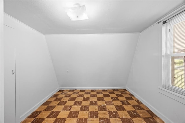 spare room featuring ornamental molding and tile patterned floors