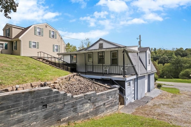 rear view of house with a lawn and a garage