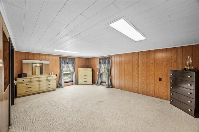 bedroom with wooden walls and carpet floors