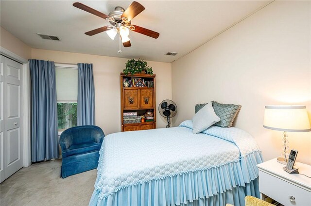 carpeted bedroom with a closet and ceiling fan