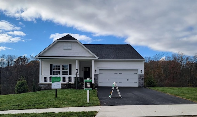 craftsman-style house featuring a porch, a garage, and a front lawn