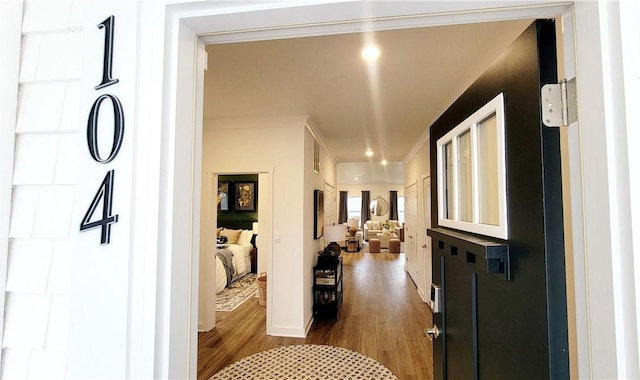 hallway featuring crown molding and dark wood-type flooring